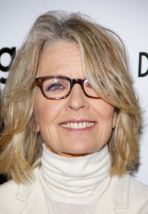 Diane Keaton has dusty blone highlights and soft face framing layers in her hair.